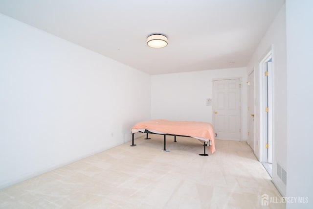 bedroom featuring light carpet