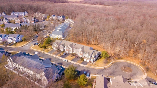 bird's eye view with a wooded view and a residential view