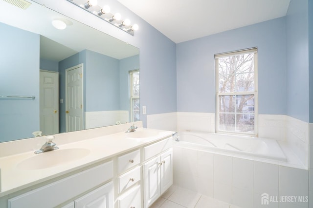 full bathroom featuring a sink, double vanity, visible vents, tile patterned floors, and a garden tub