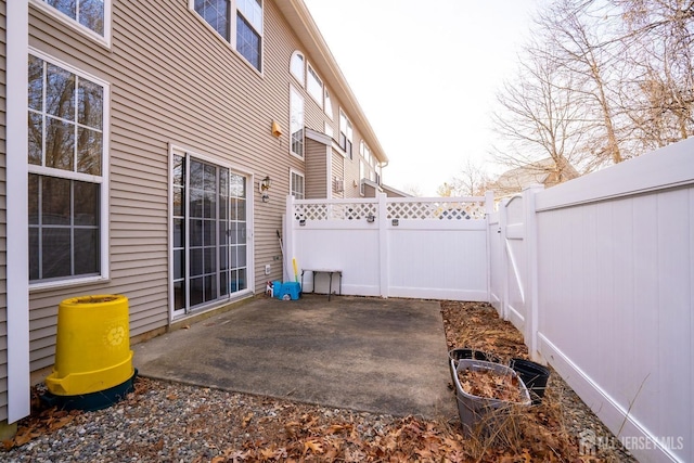view of patio with fence and a gate