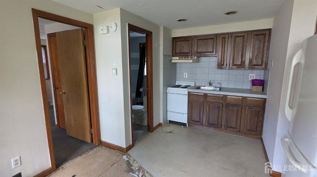 kitchen with white appliances, under cabinet range hood, tasteful backsplash, tile counters, and a sink