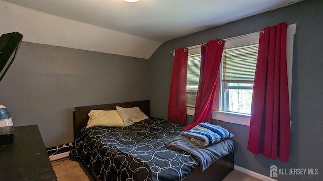 carpeted bedroom featuring vaulted ceiling