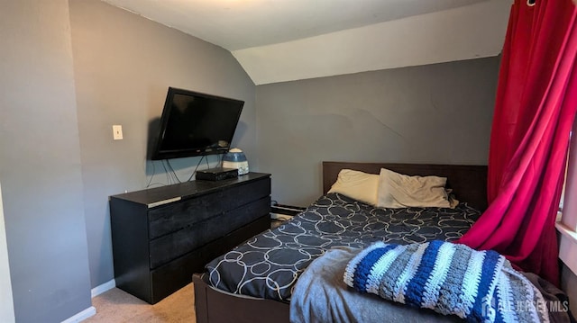 bedroom featuring lofted ceiling and carpet flooring