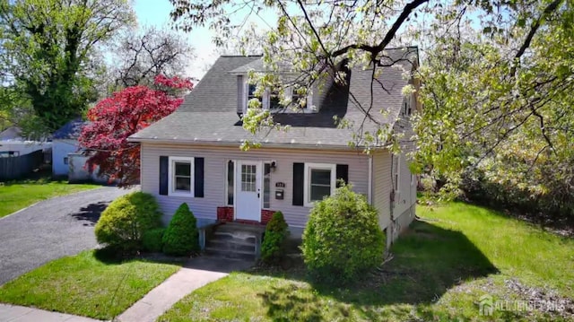 cape cod-style house with a front lawn