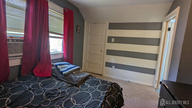 carpeted bedroom featuring vaulted ceiling and cooling unit