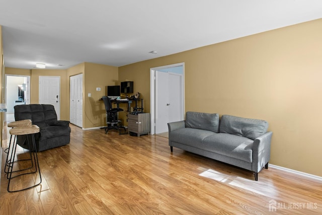 6072 Cedar Ct, South Brunswick, NJ 08852 - living area with light wood-style floors, a desk, and baseboards