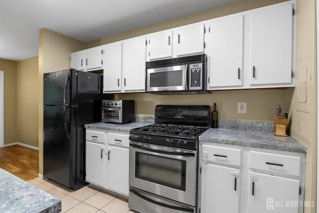 6072 Cedar Ct, South Brunswick, NJ 08852 - kitchen featuring stainless steel appliances, white cabinetry, light countertops, light tile patterned floors, and baseboards
