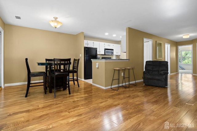 6072 Cedar Ct, South Brunswick, NJ 08852 - dining space featuring light wood-style floors and baseboards