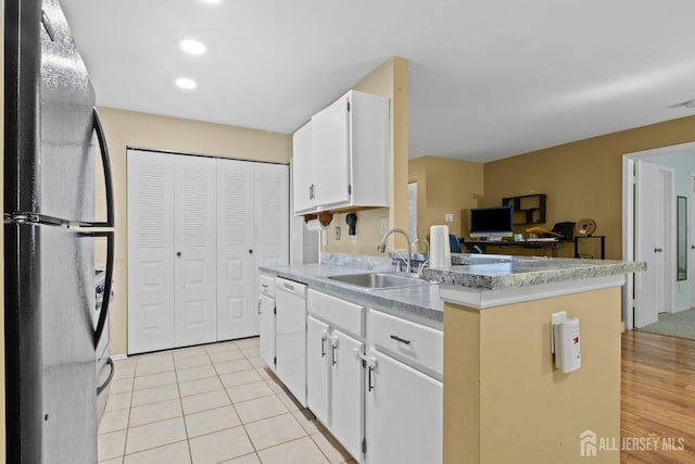 6072 Cedar Ct, South Brunswick, NJ 08852 - kitchen featuring freestanding refrigerator, a sink, light countertops, white cabinets, and dishwasher