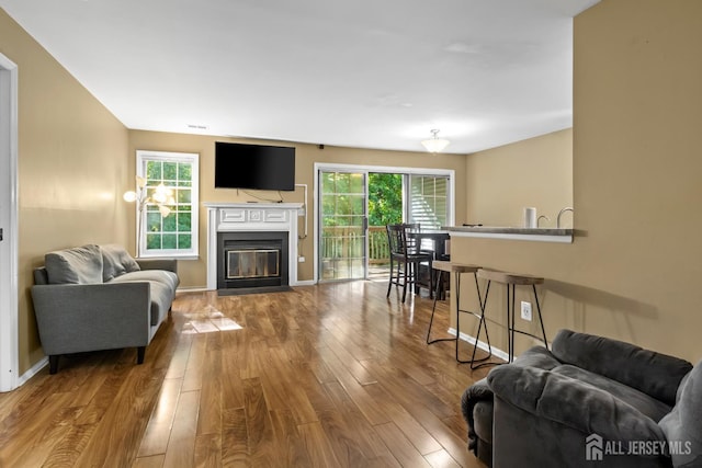 6072 Cedar Ct, South Brunswick, NJ 08852 - living area with wood finished floors, baseboards, and a fireplace with flush hearth