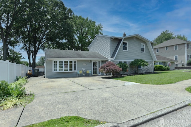 100 Woodland Ave, Fords, NJ 08863 - rear view of property with driveway, a chimney, and stone siding