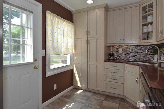 100 Woodland Ave, Fords, NJ 08863 - kitchen featuring backsplash, glass insert cabinets, dishwashing machine, and dark countertops