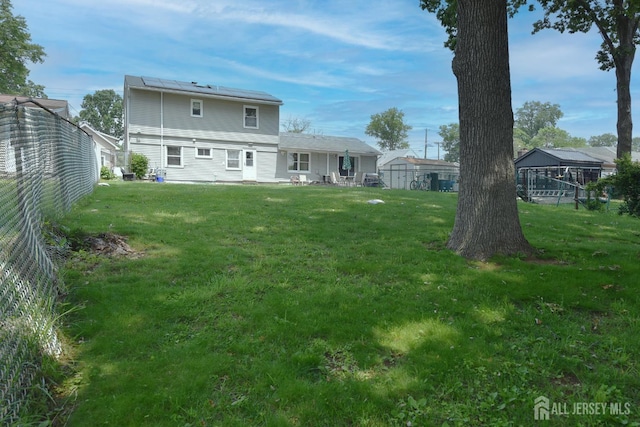 100 Woodland Ave, Fords, NJ 08863 - rear view of house with a lawn