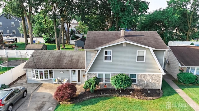 100 Woodland Ave, Fords, NJ 08863 - view of front of property featuring stone siding and a shingled roof