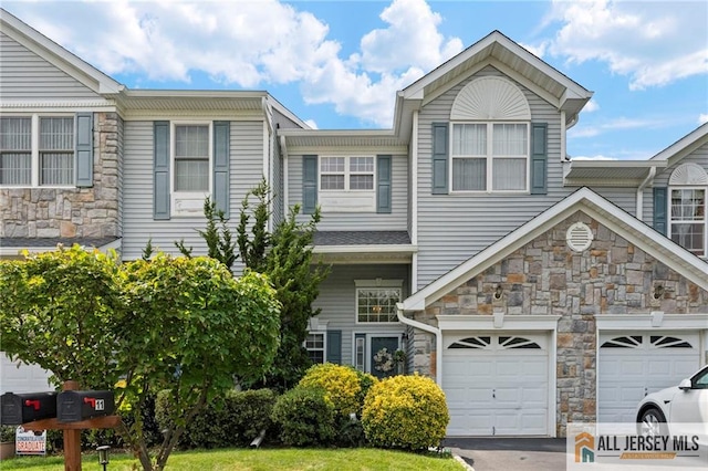 11 Rondell Ln, South Amboy, NJ 08879 - view of front of house featuring stone siding, asphalt driveway, and a garage