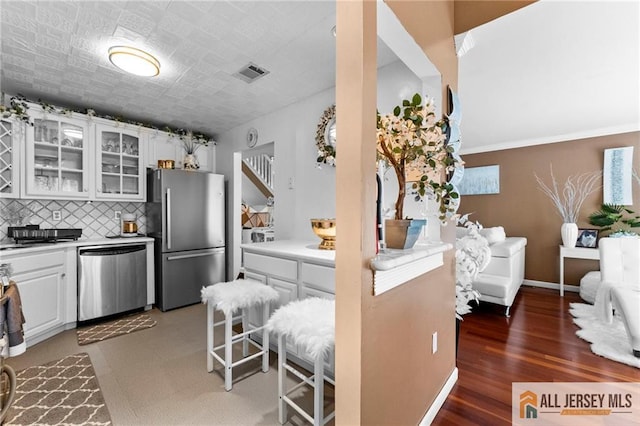11 Rondell Ln, South Amboy, NJ 08879 - kitchen with appliances with stainless steel finishes, white cabinetry, glass insert cabinets, backsplash, and light countertops