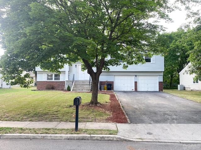 view of front of property with a garage and a front lawn