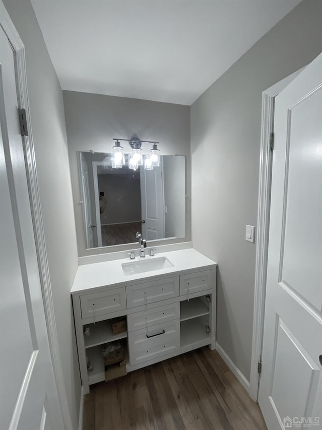 bathroom with hardwood / wood-style floors and vanity