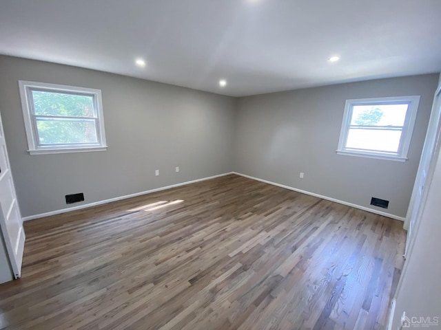 spare room with wood-type flooring