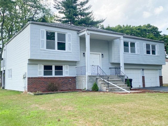 split foyer home with a garage and a front lawn