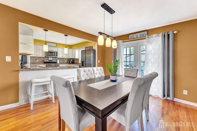 114 Jeffery Rd, Colonia, NJ 07067 - dining space with baseboards, light wood-style floors, and french doors