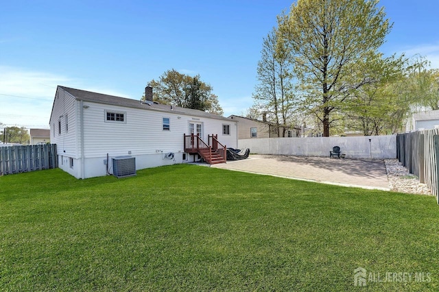 114 Jeffery Rd, Colonia, NJ 07067 - back of house featuring central AC unit, a chimney, and a patio