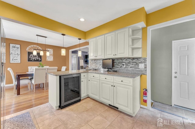 114 Jeffery Rd, Colonia, NJ 07067 - kitchen with wine cooler, open shelves, white cabinets, a peninsula, and recessed lighting