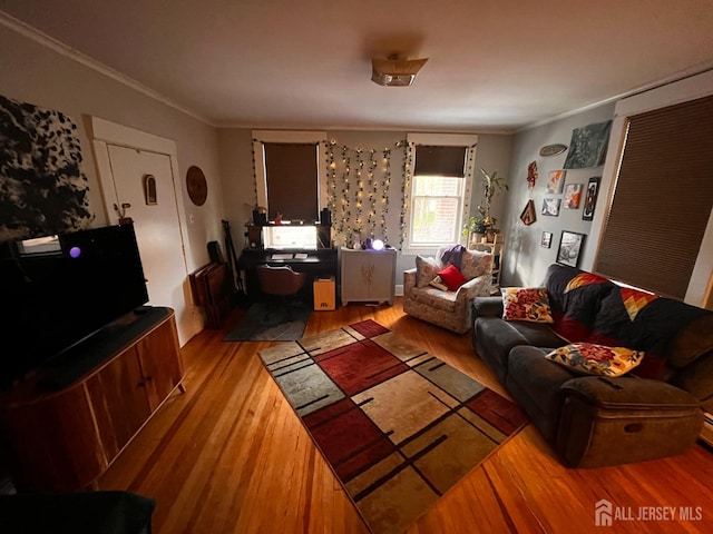 living room with wood finished floors and ornamental molding