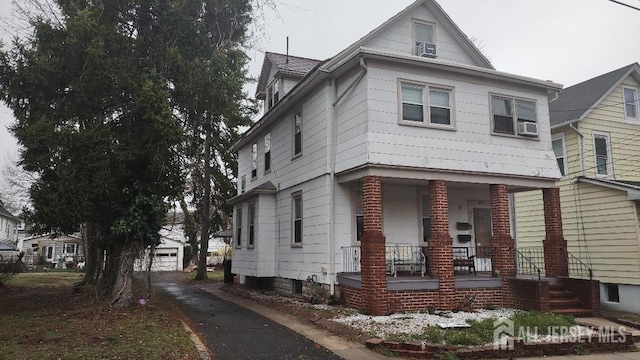 view of front of property with a porch and an outbuilding