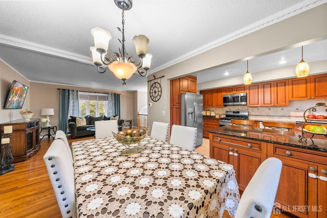 17 4th St, South River, NJ 08882 - dining room featuring a chandelier, crown molding, light wood finished floors, and a textured ceiling