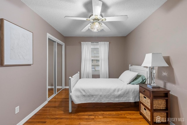 17 4th St, South River, NJ 08882 - bedroom featuring wood finished floors, a textured ceiling, baseboards, a closet, and a ceiling fan