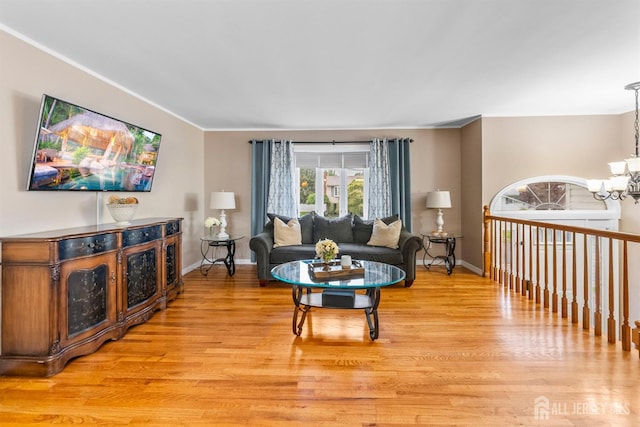 17 4th St, South River, NJ 08882 - living room featuring light wood-style floors, a chandelier, baseboards, and ornamental molding