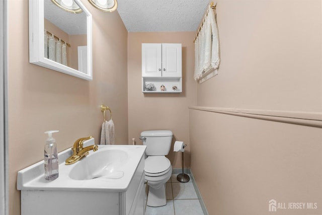 17 4th St, South River, NJ 08882 - bathroom featuring toilet, tile patterned flooring, a textured ceiling, vanity, and baseboards