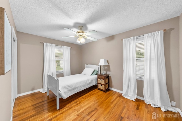17 4th St, South River, NJ 08882 - bedroom featuring light wood finished floors, a textured ceiling, and a ceiling fan