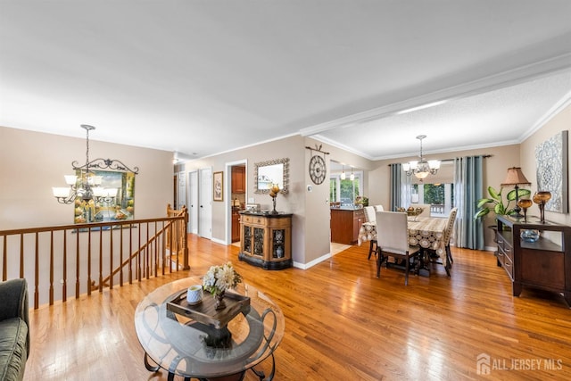 17 4th St, South River, NJ 08882 - living room with a chandelier, light wood-type flooring, ornamental molding, and baseboards