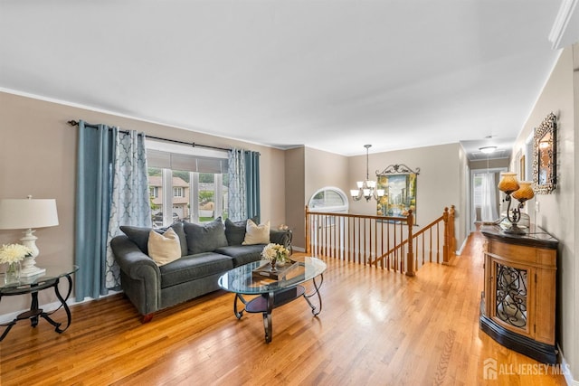 17 4th St, South River, NJ 08882 - living area featuring attic access, light wood-style floors, a chandelier, and baseboards