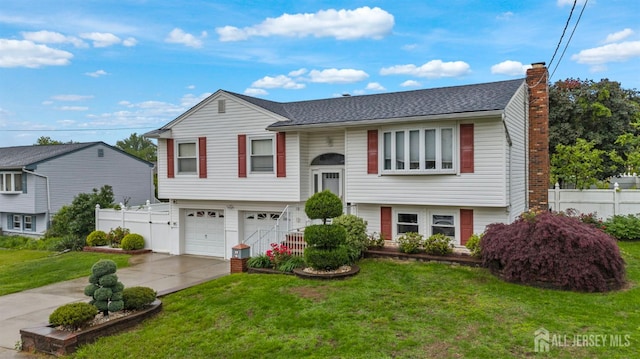 17 4th St, South River, NJ 08882 - bi-level home featuring a garage, a chimney, and driveway