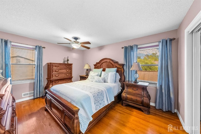 17 4th St, South River, NJ 08882 - bedroom with a textured ceiling, light wood-style floors, baseboards, and ceiling fan