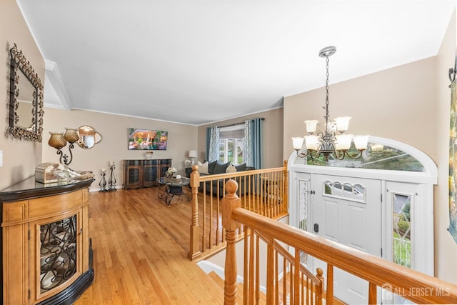 17 4th St, South River, NJ 08882 - hallway with an upstairs landing, a chandelier, plenty of natural light, light wood-type flooring, and ornamental molding