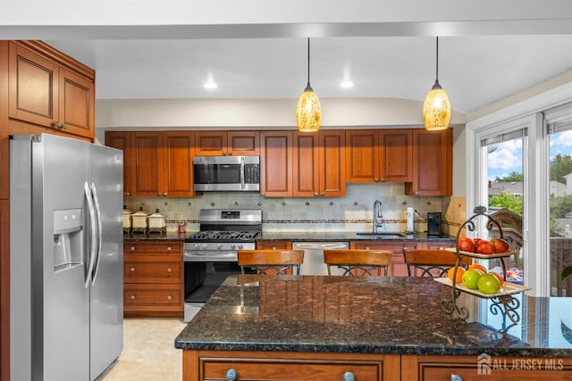 17 4th St, South River, NJ 08882 - kitchen featuring appliances with stainless steel finishes, a sink, tasteful backsplash, and hanging light fixtures