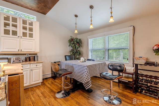 170 Jordon Rd, Colonia, NJ 07067 - dining area featuring light wood-style flooring, vaulted ceiling, a baseboard radiator, and a desk