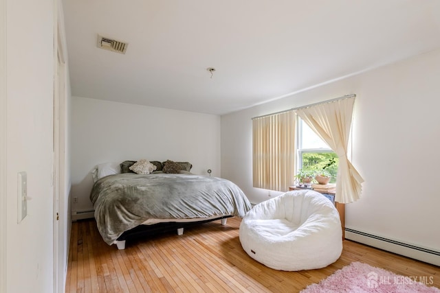 170 Jordon Rd, Colonia, NJ 07067 - bedroom featuring a baseboard heating unit and hardwood / wood-style floors