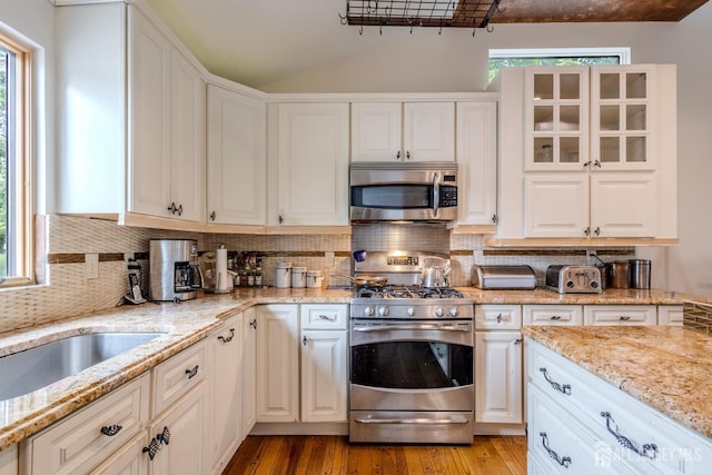 170 Jordon Rd, Colonia, NJ 07067 - kitchen featuring stainless steel appliances, vaulted ceiling, tasteful backsplash, light wood-style floors, and white cabinets