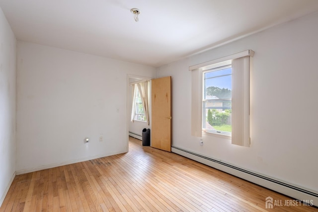 170 Jordon Rd, Colonia, NJ 07067 - empty room featuring a baseboard radiator and light wood-style floors