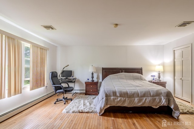 170 Jordon Rd, Colonia, NJ 07067 - bedroom with a baseboard radiator, wood-type flooring, and an office area