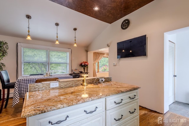 170 Jordon Rd, Colonia, NJ 07067 - kitchen featuring vaulted ceiling, light stone countertops, white cabinetry, light wood finished floors, and pendant lighting