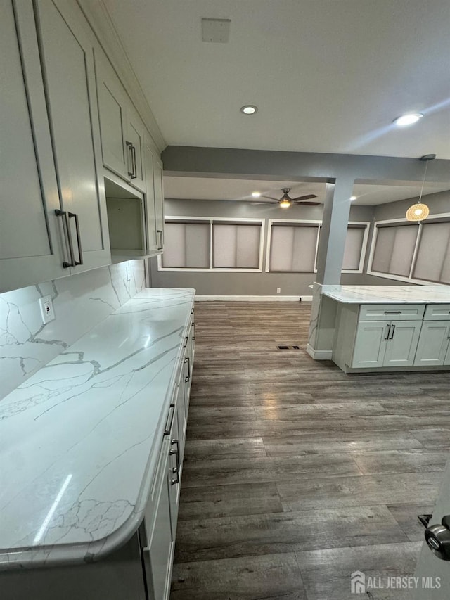 kitchen featuring ceiling fan, dark wood-style flooring, recessed lighting, light countertops, and pendant lighting