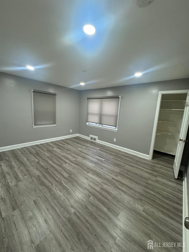 below grade area with wood finished floors, baseboards, and recessed lighting