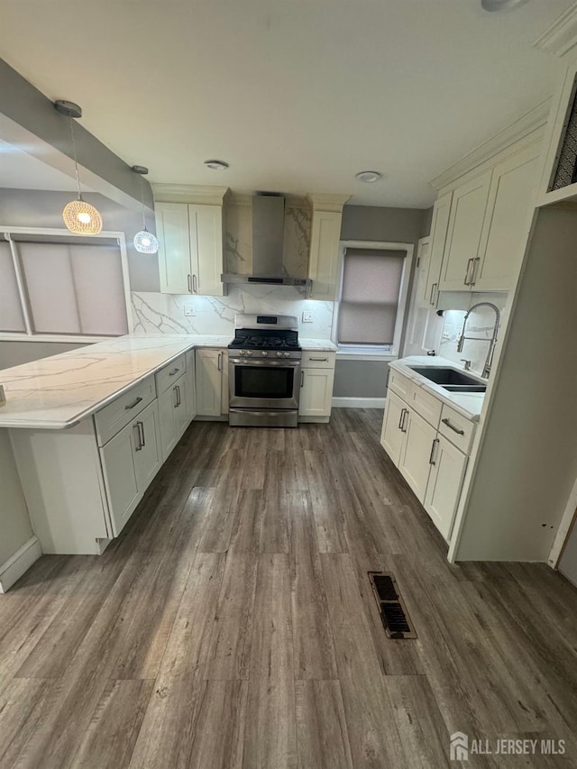 64 Post Blvd, Carteret, NJ 07008 - kitchen featuring gas stove, wall chimney range hood, a sink, dark wood finished floors, and decorative backsplash
