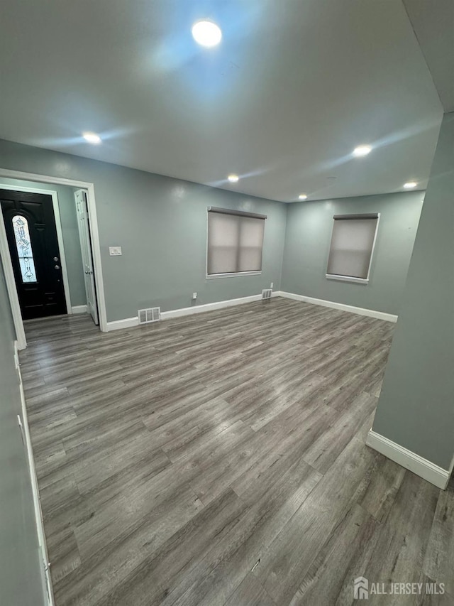 below grade area featuring wood finished floors, baseboards, and recessed lighting